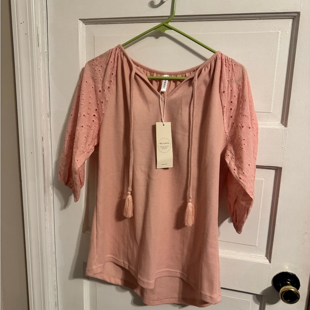 Pink 3/4 sleeve shirt with floral details